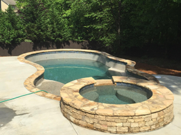 Outdoor spa with a hot tub built by Premier Pool Inc.