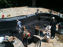 Premier Pool Construction, LLC team performing pool plastering.