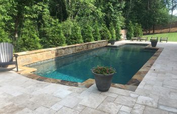 Backyard swimming pool with steps installed by Premier Pool Enterprises