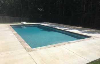 Backyard swimming pool installed by Premier Pool Enterprises