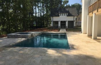 Backyard swimming pool with hot tub installed by Premier Pool Enterprises