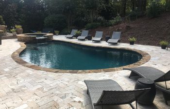 Backyard swimming pool with hot tub installed by Premier Pool Enterprises