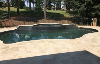 Backyard swimming pool with hot tub installed by Premier Pool Enterprises