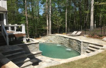 home with an outdoor pool and hardscaped water features