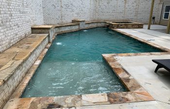 home with an outdoor swimming pool with water features