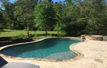 backyard paver patio with swimming pool and hot tub