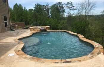 home with backyard swimming pool with hot tub and water features