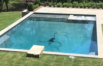 Cleaning equipment in backyard swimming pool