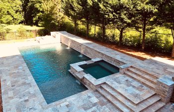 modern backyard swimming pool with hot tub and water features