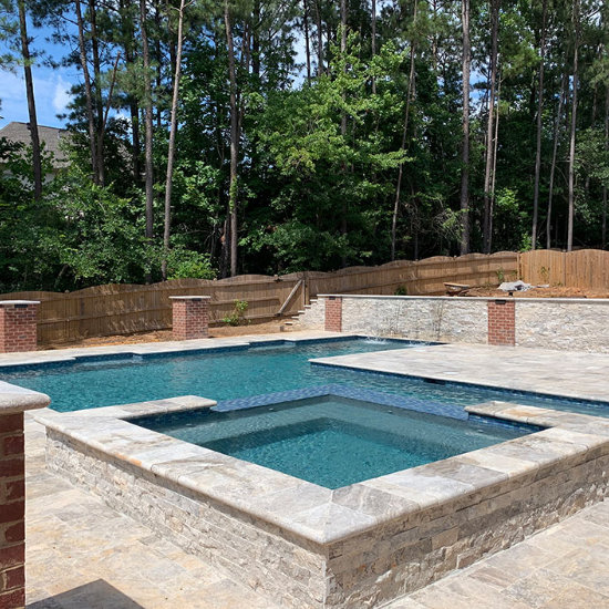 backyard swimming pool with water features
